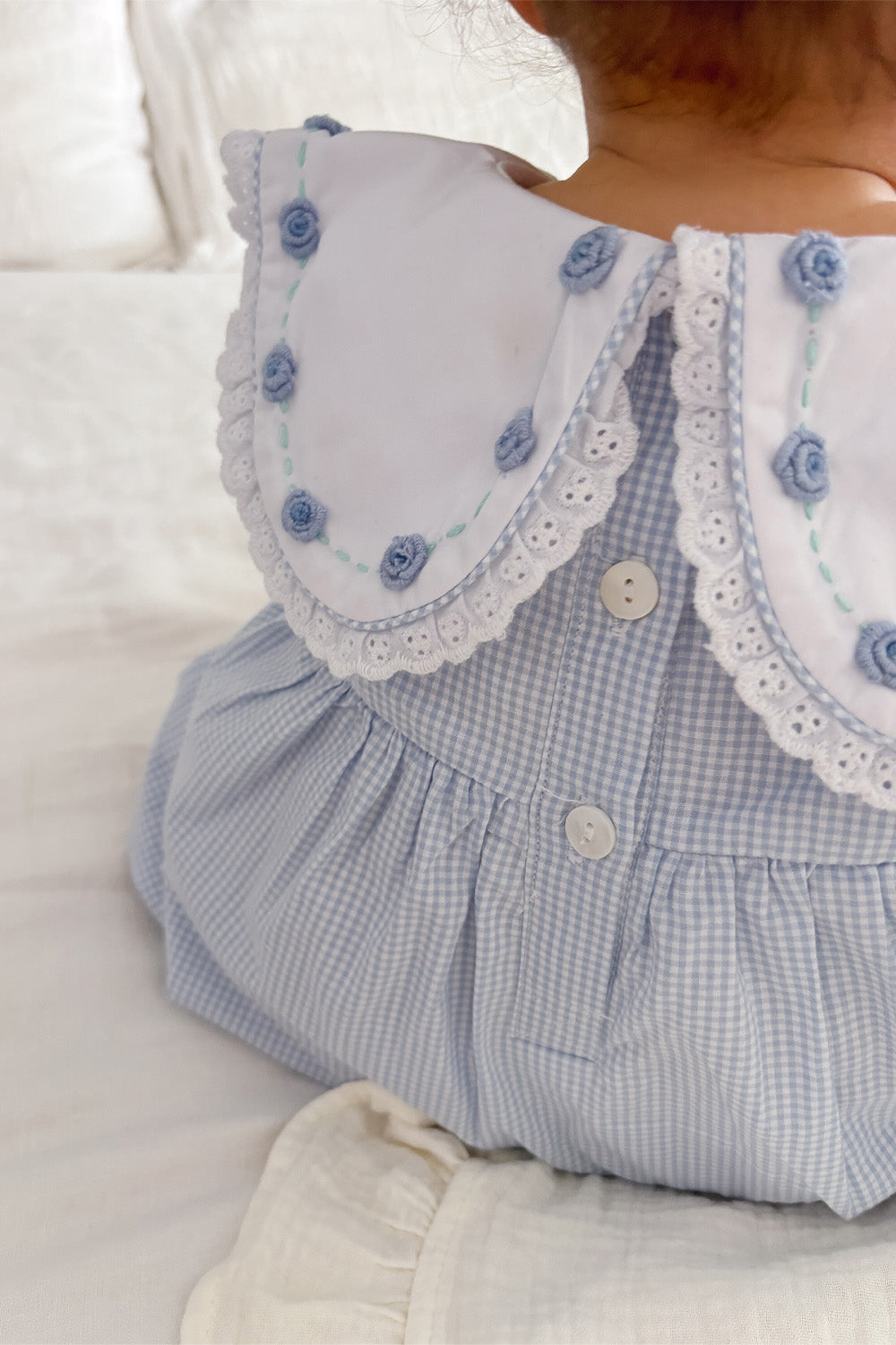 Back view of blue gingham romper collar with embroidered roses and lace trim