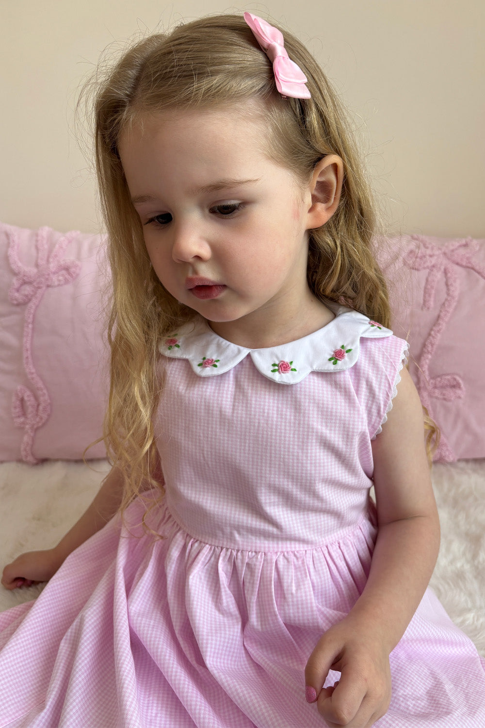 Girl wearing Pink Gingham Rose Dress with scalloped Peter Pan collar